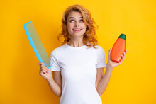 Happy Smiling Woman Hold Bottle Shampoo And Conditioner. Funny Girl Combing Hair. Redhead Woman With A Comb, Isolated On Yellow Background.