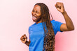 © Asier - Young african american woman isolated on pink background dancing and having fun.