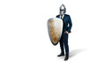 Creative image, a man in a suit of a businessman, a knight's helmet on his head on a white background. The concept of a modern hero, overcoming difficulties, crisis management. magazine style