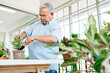 © artitwpd - Asian retired grandfathers love to take care of the plants by scooping the soil in preparation for planting trees. Retirement activities.