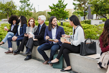 Wall Mural - Group of multiracial people eating together during lunch break outside of office