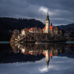 Wall Mural - Lake Bled, Slovenia - Beautiful view of Lake Bled (Blejsko Jezero) with reflecting Pilgrimage Church of the Assumption of Maria on Bled Island, with Pletna boat at winter time