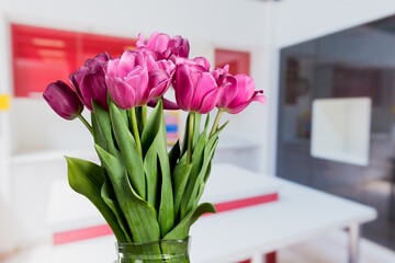 Wall Mural - A bouquet of flowers on a table. In the background, the interior of a kitchen. The concept of home comfort.