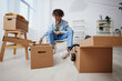 © SHOTPRIME STUDIO - handsome guy sitting on a chair with boxes moving interior