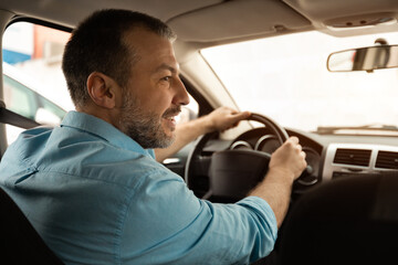 Confident man test driving new car in city