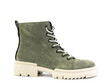 Green suede boots with white laces and zipper on the side. Elasticated side details and white rubber sole. Isolated close-up on white background.