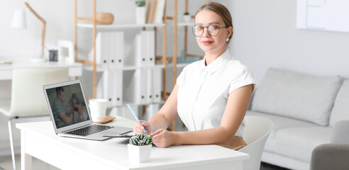 Wall Mural - Psychologist working with patients online from her office