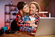 © sofiko14 - Focused caucasian man working on modern laptop during evening time and his girlfriend hugs him from back. Concept of people, home routine, freelance and deadline.
