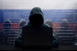 © famveldman - Russian hacker at laptop. Malware and virus.