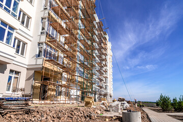 completion of residential building construction facade finishing using scaffolding