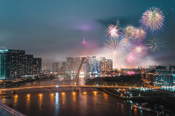 Wall Mural - Celebration. Landmark 81 skyscraper with fireworks light up sky over business district in Ho Chi Minh City ( Saigon ), Vietnam. New Thu Thiem bridge in night view.  Holidays, celebrating New Year