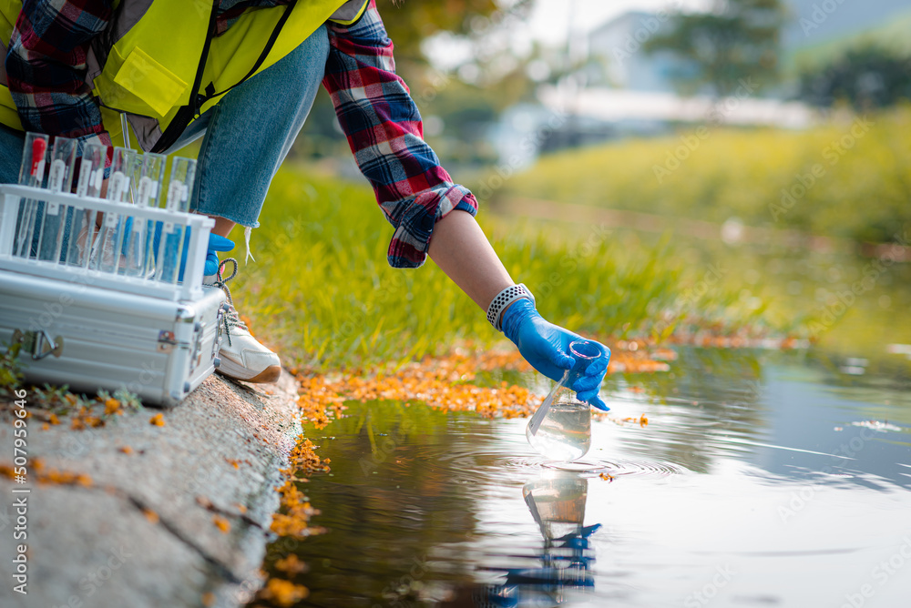 Hands of scientists collecting water samples for analysis and research ...