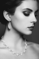 Wall Mural - Fashion portrait of young beautiful woman with jewelry. Black and white photo. Perfect make-up.  Beauty style woman with diamond accessories