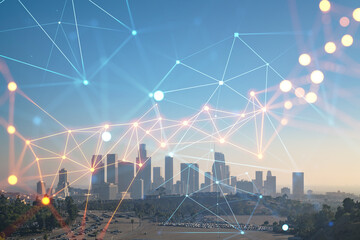 Skyline panorama of Los Angeles downtown at sunset, California, USA. Skyscrapers of LA city. Glowing Social media icons. The concept of networking and establishing new connections between people