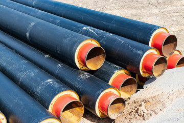 Wall Mural - Insulated pipe. Large metal pipes with a plastic sheath at a construction site. Modern pipeline for supplying hot water and heating to a residential area.