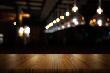 Wall Mural - Empty wooden table top with blurred coffee shop or restaurant interior background.