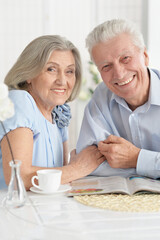 Sticker - Portrait of mature couple with magazine drinking tea