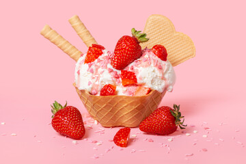 cone with scoops of ice cream strewed sprinkles, poured with glaze and decorated strawberries on pink background