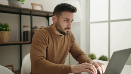 Sticker - Young hispanic man using laptop sitting on table at home