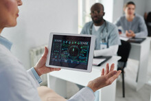 Close-up Of Mature Lecturer Holding Digital Tablet With Graphs In His Hands And Talking To Students During Medical Training