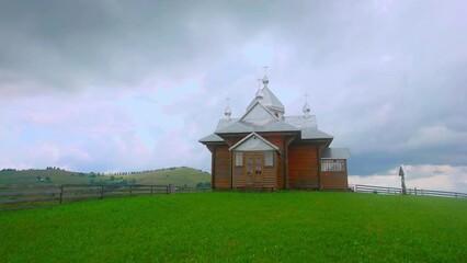 Wall Mural - The timber church against the cludy rainy sky, Verkhovyna, Carpathians, Ukraine