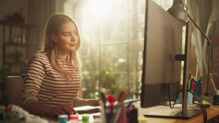 Poster - Portrait of Creative Female Smiling, Checking Social Media and Websites at her Personal Computer while Sitting on Couch in Stylish Loft Apartment on a Sunny Day. Big Window at the Background