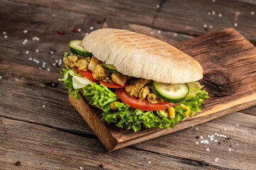 Wall Mural - Grilled club sandwich panini with crispy chicken and salad on cutting board. Delicious breakfast or snack. copy space