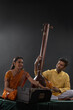 © IndiaPix - Man and woman performing together with Tanpura and harmonium in a classical musical concert