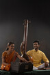 © IndiaPix - Man and woman performing together with Tanpura and harmonium in a classical musical concert