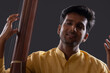 © IndiaPix - Close-up view of a male musician performing with Tanpura at concert