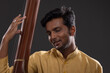 © IndiaPix - Close-up view of a male musician performing with Tanpura at concert