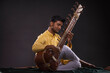 © IndiaPix - Portrait of young man performing with Sitar at concert