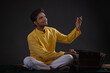 © IndiaPix - Portrait of young man performing with Harmonium at concert