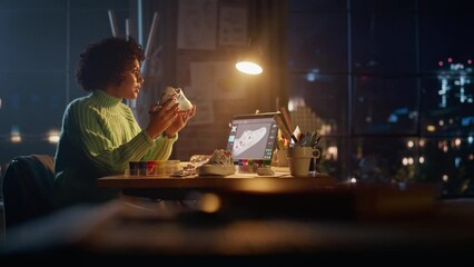 Poster - Diverse Female Designer Holding Shoe Like an Art Object and Checking with 3d Model at Laptop while Drawing on it. Woman is Customising Footwear at Evening. Art and Small Business Concept