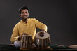 © IndiaPix - Portrait of cheering young man performing with Tabla on stage