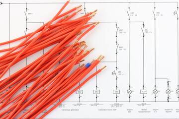 Colored copper wires on an electrical diagram in close-up.