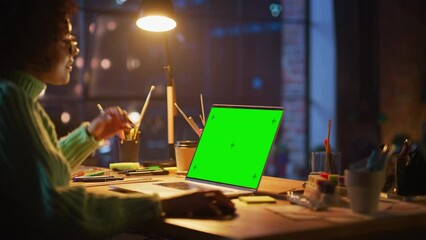 Poster - Black Female Creator Zoom On and Zoom Out with Computer Mouse while Modeling on Laptop Computer with Green Chroma Key Screen. Freelance Woman Working at her Project