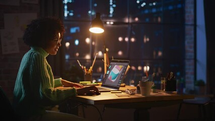 Poster - Concentrated Black Female Gamer Using Laptop Computer while Design Video Game with Creative Software. Woman Using Mouse while Examining Object. Creative Mess at the Table