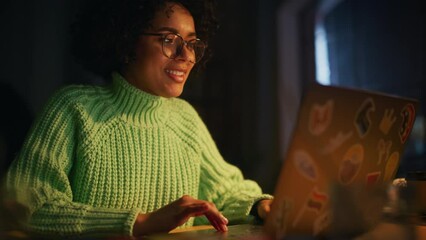 Poster - Portrait of a Cute Teenage Multiethnic Girl Using Laptop Computer in Stylish Loft Apartment in the Evening. Creative Female Student Preparing Her Homework. People and Technologies Concept. Slow Motion