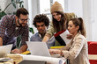 © BalanceFormCreative - Group of casually dressed young businesspeople discussing ideas at the office for a new startup project.Female coworker talking about business strategy.