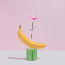 Minimal Summer Or Spring Concept With Pink Flower, Yellow Banana And Green Candle.Fun Healthy Natural Living Aesthetic.