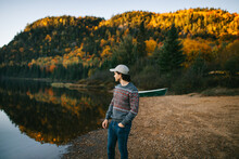 Stylish Traveling Guy Standing At Lakeside On Autumn Day