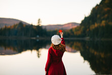 Elegant Lady Holding Red Leaf On Lake Shore On Autumn Day