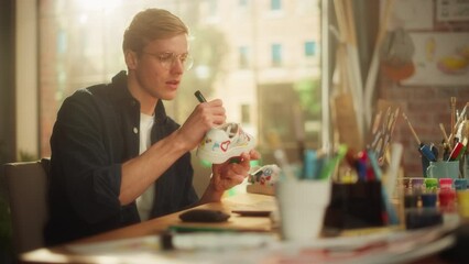 Leinwandbilder - Fashion Designer in Process of Creating New Custom Made Exclusive Shoes in His Workshop. Millennial Teenage Male Artist Looking on Hype Sneakers and Feeling Satisfied. Moving Shot