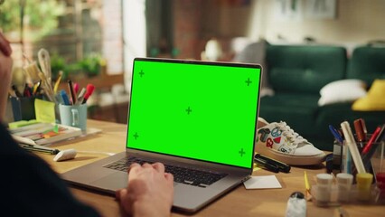Poster - Male Specialist Working on Desktop Computer with Green Screen Mock Up Display at Loft Modern Place. Teenage Freelancer Using his Laptop. Close Up Over the Shoulder
