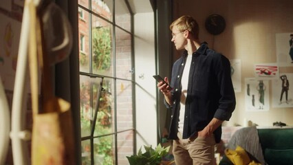 Aufkleber - Caucasian Man Using Smartphone while Resting at Home. Happy Male Blogger Creating Content and Chatting to Subscribers Over the Internet. Using Social Networks Concept