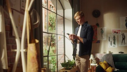 Aufkleber - Portrait of a Handsome Man Using Smaphone, Receives Good News, Successful e-Commerce Sale, New Freelance Order Email, Stocks are Growing, Social Media Dating. Creative Young Man in Apartment Studio