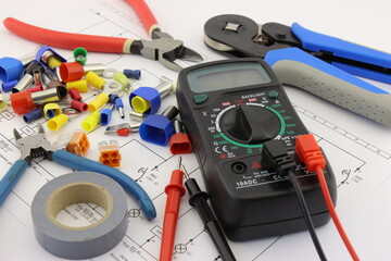 Wall Mural - Multimeter and mounting tools in the electrical diagram close-up.