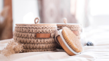 woven jute basket with natural body care products with body brush in bathroom near mirror. Beige interior Natural hygiene products. Zero waste concept.