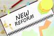 New Reforms. text on planner on wooden background